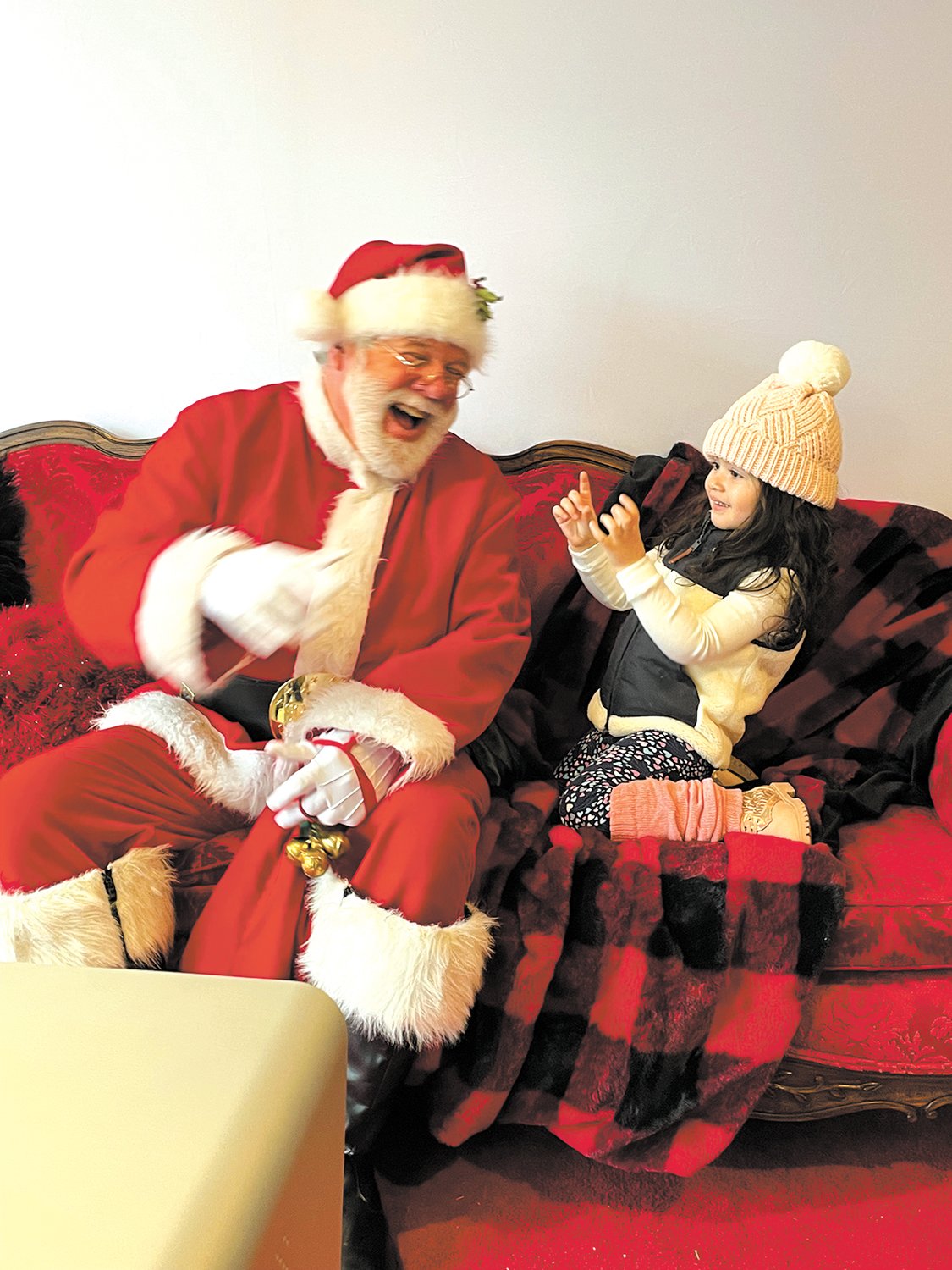 THE MAGIC IS REAL: Santa certainly was amused by his little visitor, Ella Villaman at the “Cops and Kids Holiday Party” at the Park Theatre on Dec. 3.
